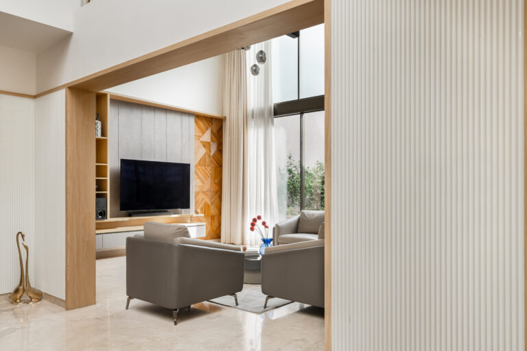 A seamless open-plan living area showcasing tactile micro-cement flooring and a fluid layout.